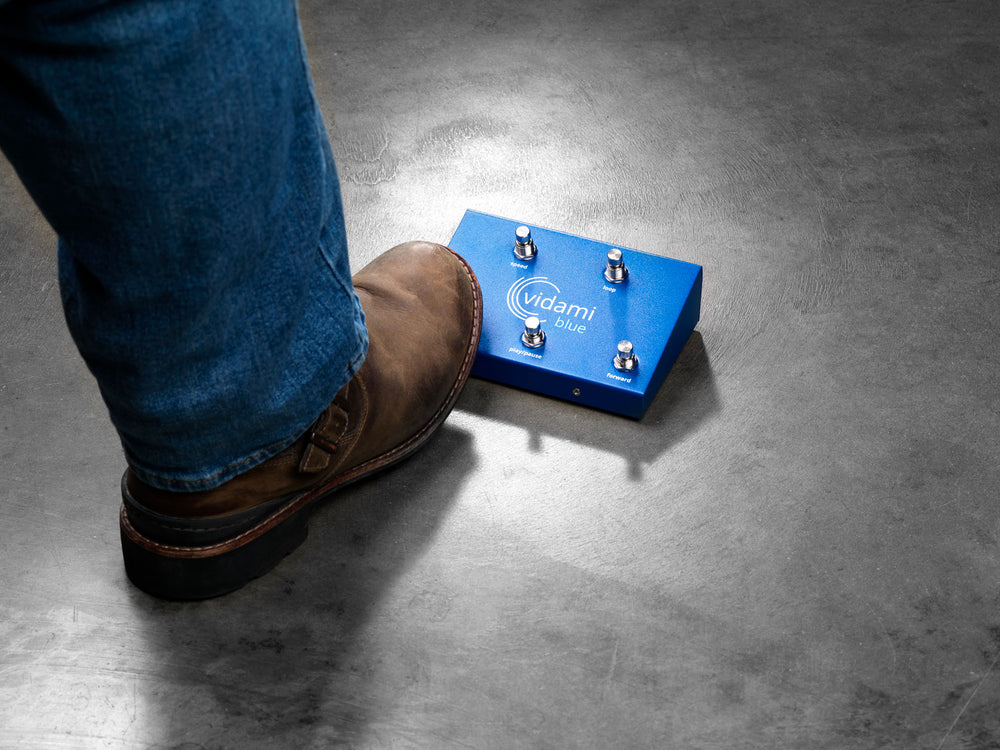 
                  
                    A foot presses on of the switches on the Vidami Blue
                  
                